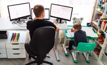 Father and child working side by side. 
